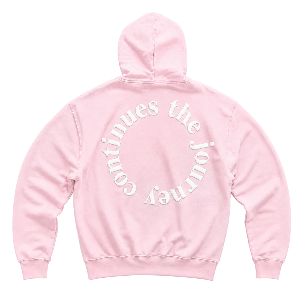 A light pink pullover hoodie shown from the back, featuring the phrase 'the journey Continues' printed in white curved text across the upper back.